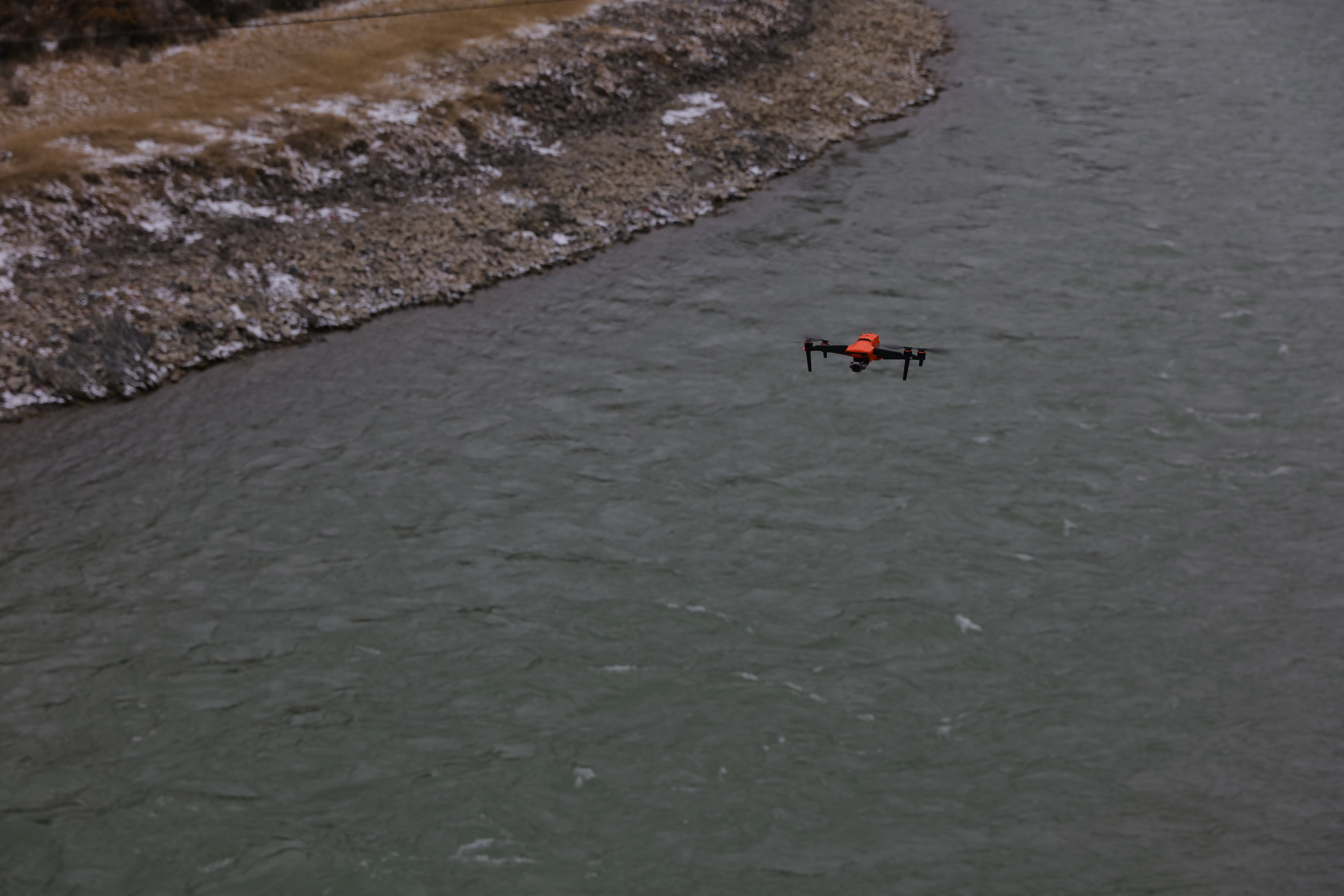 Drone flying over riverbank